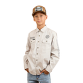 A boy wears a Ringers Western Childrens Jackaroo Full Button L/S Work Shirt (321012RW) in beige with embroidered logos, blue jeans, and a brown and white trucker hat, posing with one hand in his pocket against a plain white background.