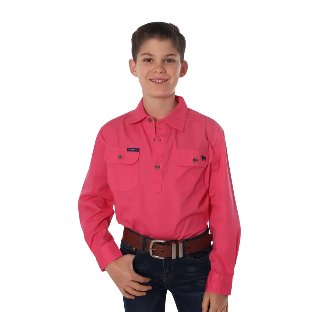 A smiling boy stands with one hand in his pocket, wearing the Ringers Western Childrens Ord River Half Button L/S Work Shirt (171310001) in Melon, dark jeans, and a brown belt against a white background.