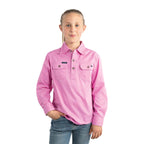 A young girl with light brown hair in a ponytail wears a Ringers Western Childrens Ord River Half Button L/S Work Shirt (171310001) in Pastel Pink and blue jeans, standing against a white background—offering comfort and sun protection.
