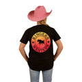 A person wearing a pink cowboy hat, blue jeans, and a Ringers Western Childrens Signature Bull Classic S/S Tee (320004RW) Black Fade stands facing away against a white background.