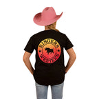 A person wearing a pink cowboy hat, blue jeans, and a Ringers Western Childrens Signature Bull Classic S/S Tee (320004RW) Black Fade stands facing away against a white background.