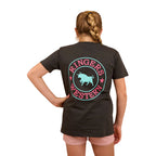 A girl with a braid wears the Ringers Western Childrens Signature Bull Classic S/S Tee (320004RW) in Charcoal/Multi, featuring the bold bull logo on the back, paired with pink shorts and standing confidently with one hand on her hip.