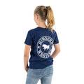 A young girl with a ponytail faces away, wearing a Ringers Western Childrens Signature Bull Classic S/S Tee (320004RW) in navy with white print and blue jeans, set against a white background.
