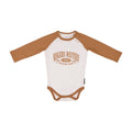 The Ringers Western Infants Western Bub L/S Romper (525010RW) in White/Clay features brown sleeves and trim, a "RINGERS WESTERN 2012 WESTERN WEAR" print, and is made from 100% cotton—ideal for little fans of western style.
