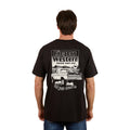 A man wears the Ringers Western Mens Get Your Truck On Loose Fit Tee in black, featuring a pickup truck graphic and "Ringers Western, Truckin' Since 2012, Get your truck on" on the back, embodying a relaxed country vibe.