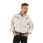 A man with short dark hair wears the Ringers Western Mens Hawkeye Full Button L/S Work Shirt (118110002) in Beige/Red, featuring "RINGERS WESTERN" text on the chest and sleeve. He pairs it with black pants, a belt, and stands hands in pockets.