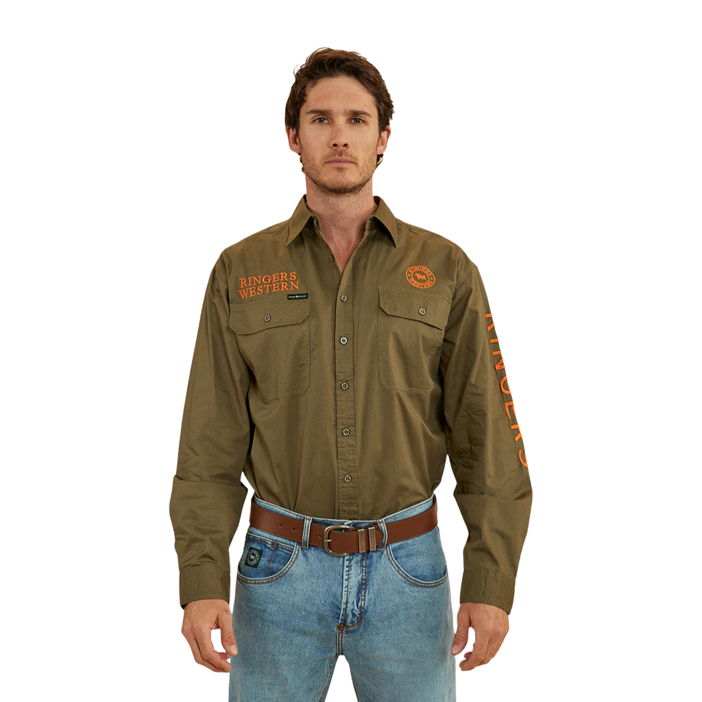 A man wears the Ringers Western Mens Hawkeye Full Button L/S Work Shirt in Military Green/Orange, featuring "Ringers Western" text on the chest and sleeve, tucked into blue jeans, standing against a white background.