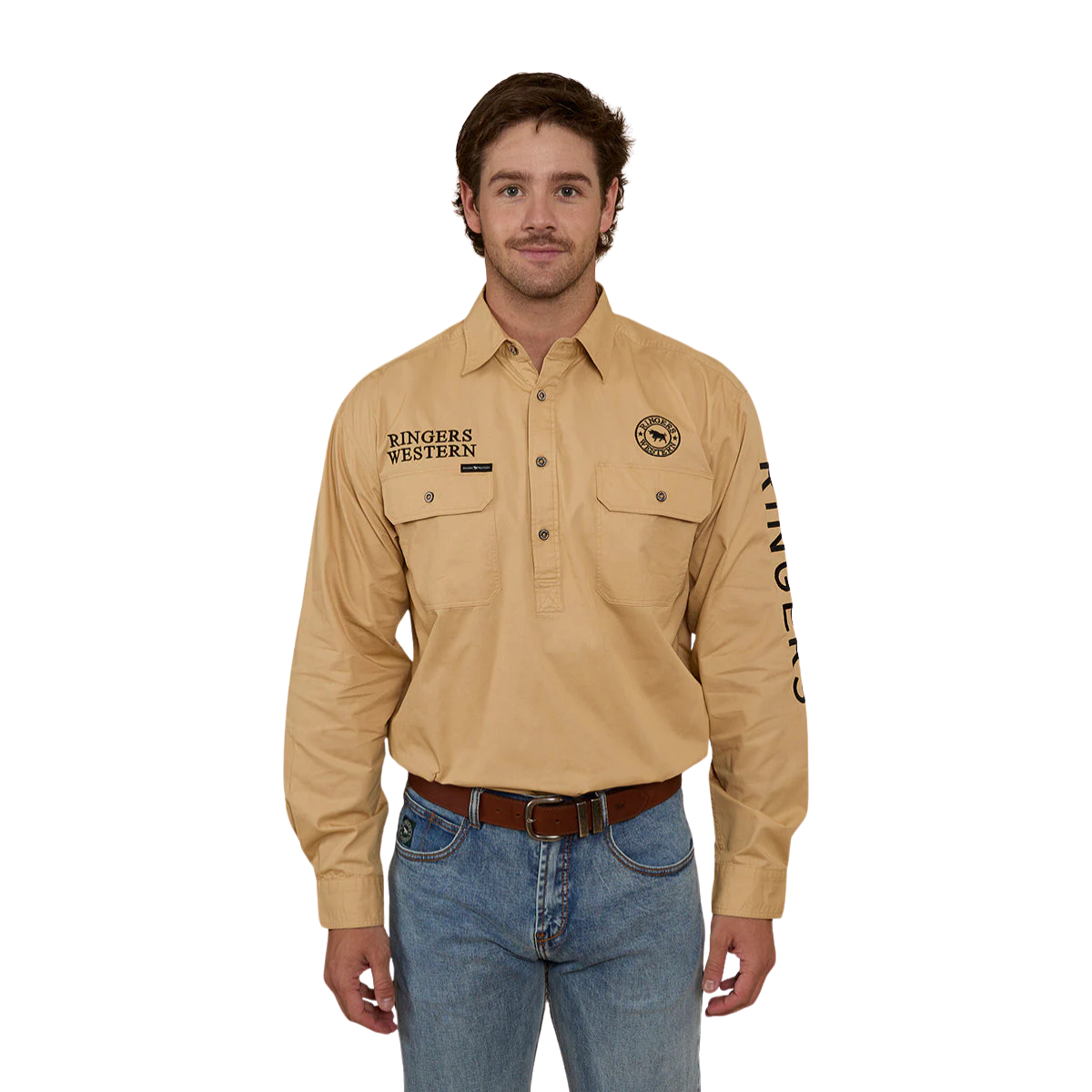 A man wearing a Ringers Western Mens Hawkeye Half Button L/S Work Shirt in Dark Sand, blue jeans, and a belt stands facing forward against a plain white background.