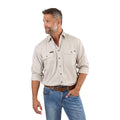A man with short gray hair and a beard, wearing a Beige Ringers Western Mens King River Full Button Work Shirt (171110001) with rolled sleeves and double breast pockets, stands with one hand by his side, looking left against a white background.
