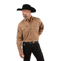 A man in a black cowboy hat, black jeans, and a Ringers Western Mens King River Full Button L/S Work Shirt (171110001) in Clay stands with one hand behind his back, looking to the side against a white background.