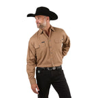 A man in a black cowboy hat, black jeans, and a Ringers Western Mens King River Full Button L/S Work Shirt (171110001) in Clay stands with one hand behind his back, looking to the side against a white background.