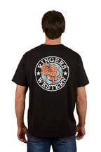 A man stands with his back to the camera, wearing the Ringers Western Mens Outta Towner Loose Fit S/S Tee in black, featuring a circular floral "Ringers Western" design—a classic Aussie outback style.