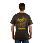 A man stands with his back to the camera wearing the Ringers Western Mens Wedge-tail Rampage Loose Fit S/S Tee in Charcoal, featuring yellow artwork of an eagle, a cowboy on a bucking bull, and "Ringers Western Since 2012.