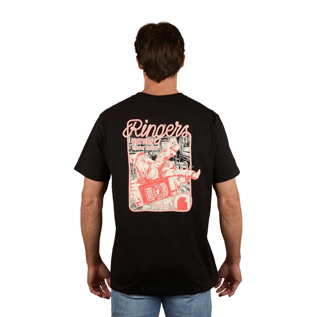A man stands against a plain white background wearing the Ringers Western Men's Whiskey Business Loose Fit S/S Tee (125036RW) in black, featuring a cartoon character with a boombox printed in red and white on the back. Crafted from 100% cotton jersey.
