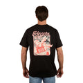 A man stands against a plain white background wearing the Ringers Western Men's Whiskey Business Loose Fit S/S Tee (125036RW) in black, featuring a cartoon character with a boombox printed in red and white on the back. Crafted from 100% cotton jersey.