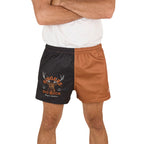 A person wearing a white shirt and Ringers Western Unisex Big Buck Footy Shorts (125019RW) in Tobacco, made from moisture-wicking polyester. Only the lower torso and upper legs are visible, highlighting a sporty country style.