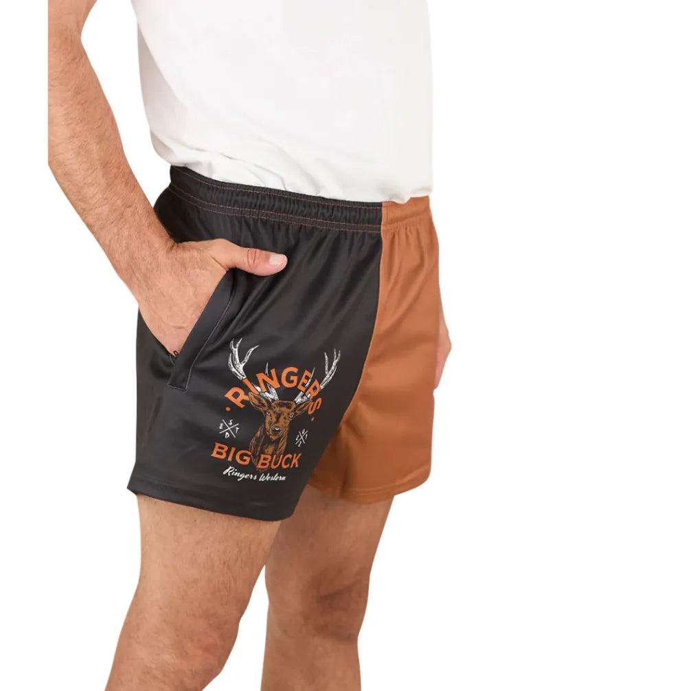 A person wearing a white shirt and Ringers Western Unisex Big Buck Footy Shorts (125019RW) in Tobacco, made from moisture-wicking polyester. Only the lower torso and upper legs are visible, highlighting a sporty country style.