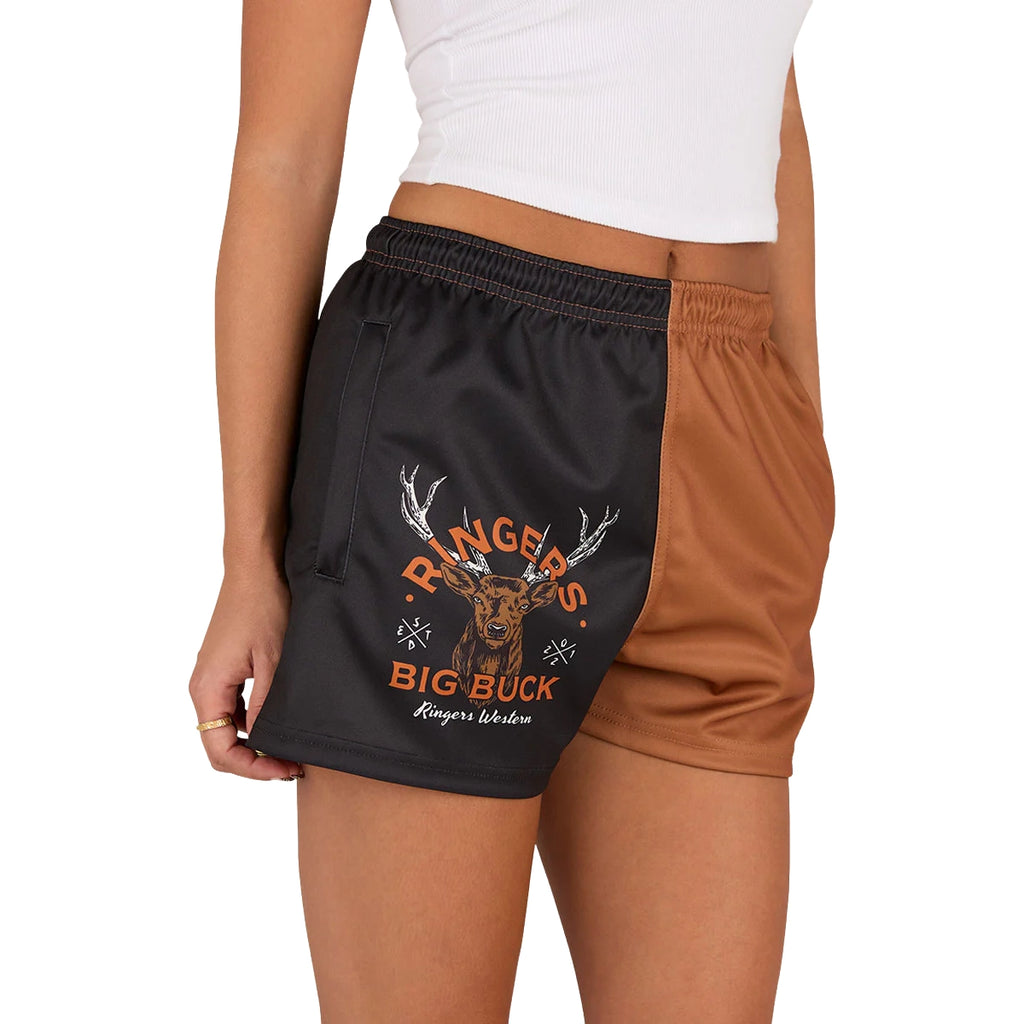 A person wearing a white shirt and Ringers Western Unisex Big Buck Footy Shorts (125019RW) in Tobacco, made from moisture-wicking polyester. Only the lower torso and upper legs are visible, highlighting a sporty country style.