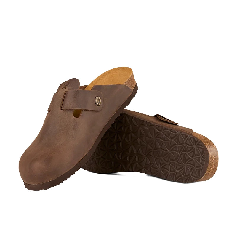 A pair of Ringers Western Unisex Byron Leather Cork Clogs (425094RW) in Tobacco, featuring cork footbeds and dark brown textured rubber soles. One clog stands upright, while the other rests side-on to display its geometric sole pattern.