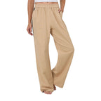 A woman wearing beige Ringers Western Alexis Elastic Waist Wide Leg Pants (225045RW) with a black side stripe featuring Ringers Western text, shown from the waist down against a plain white background.