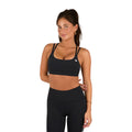 A woman in a Ringers Western Womens Anikafit Signature Crop Top (225010RW) Black stands with one hand on her hip, posing confidently and smiling slightly against a white background.