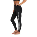 A woman stands barefoot in side profile, wearing Ringers Western Womens Anikafit Signature Leggings (225011RW) Black with "RINGERS WESTERN" in white along the left leg, made from REPREVE recycled polyester.