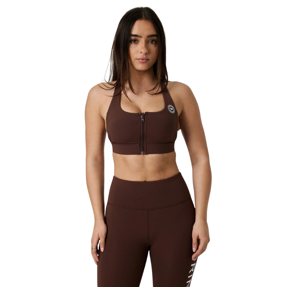 A woman modeling a matching brown activewear set consisting of a front-zip sports bra and high-waisted leggings, shown against a plain white background.