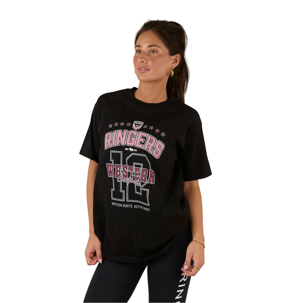 A woman with long brown hair in a ponytail wears the Ringers Western Womens Division Oversized S/S Sport Tee (225018RW) in black and black leggings, standing against a white background and looking slightly to the side.