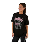 A woman with long brown hair in a ponytail wears the Ringers Western Womens Division Oversized S/S Sport Tee (225018RW) in black and black leggings, standing against a white background and looking slightly to the side.