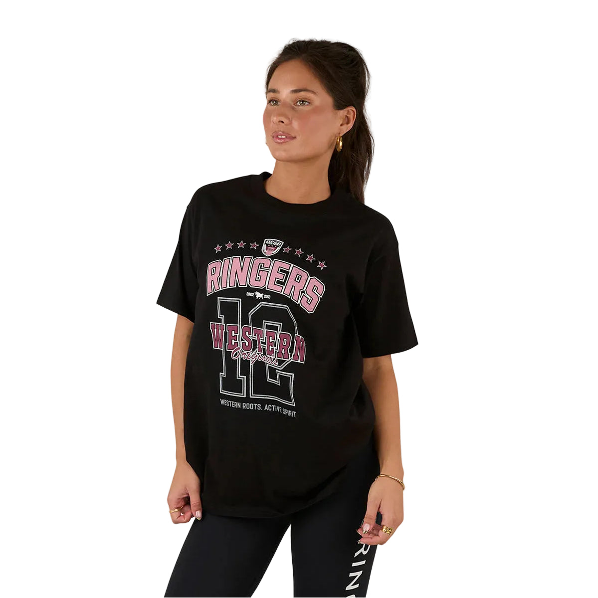 A woman with long brown hair in a ponytail wears the Ringers Western Womens Division Oversized S/S Sport Tee (225018RW) in black and black leggings, standing against a white background and looking slightly to the side.