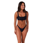 A woman modelling a black Ringers Western Women's Luna Lace Front Bralette Top (225209RW) on a white background.