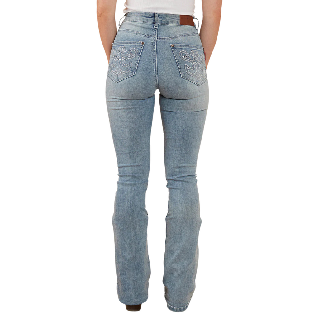 A woman wearing light blue Ringers Western Women's Penny Rodeo High Rise Bootleg Jeans (222104RW) with metallic embroidery on the back pockets, paired with a white top and brown boots, shown from behind from the waist down against a plain white studio background.