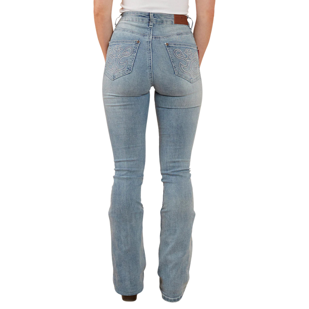 A woman wearing light blue Ringers Western Women's Penny Rodeo High Rise Bootleg Jeans (222104RW) with metallic embroidery on the back pockets, paired with a white top and brown boots, shown from behind from the waist down against a plain white studio background.