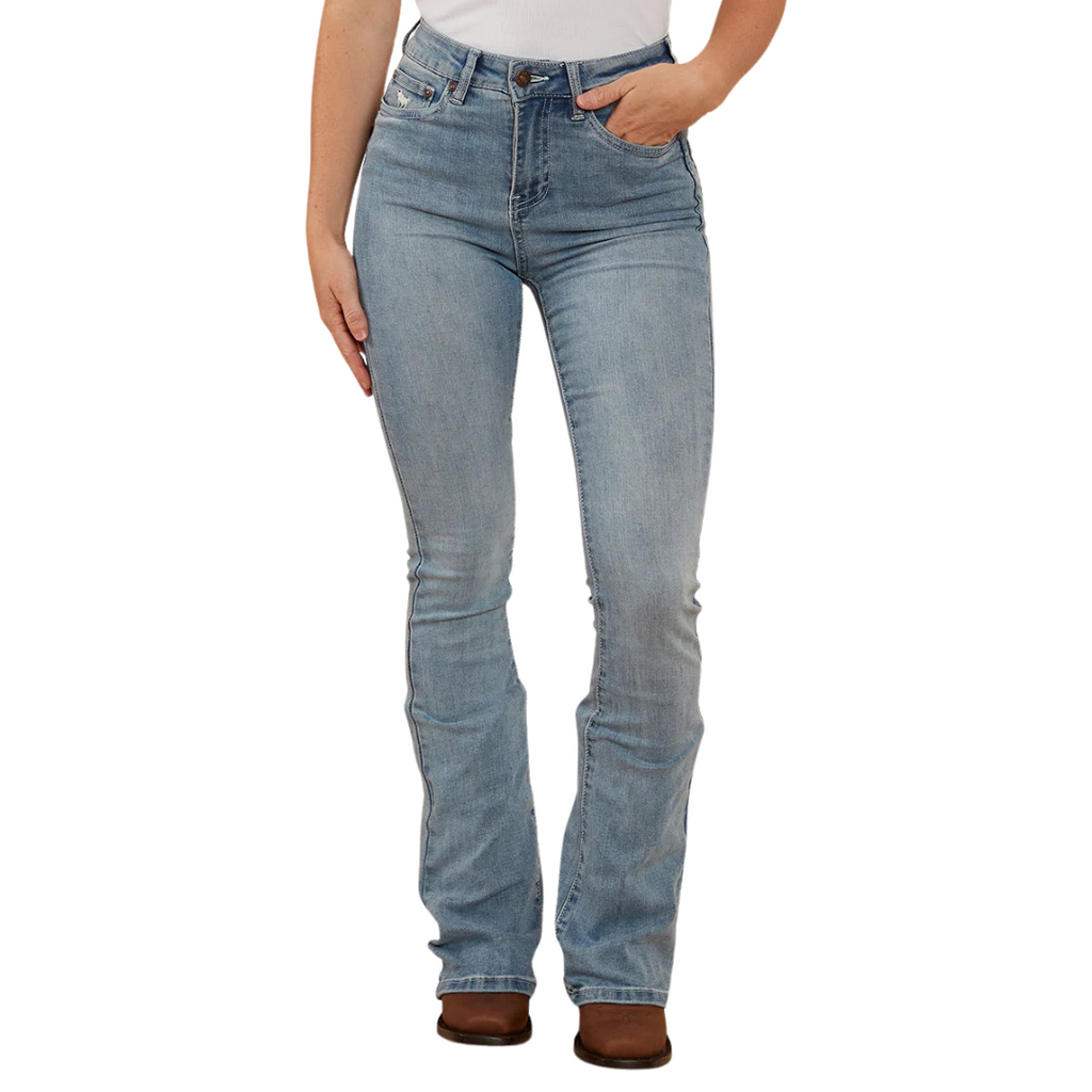 A woman wearing light blue Ringers Western Women's Penny Rodeo High Rise Bootleg Jeans (222104RW) with a white top and brown boots, shown from the waist down against a plain white studio background.