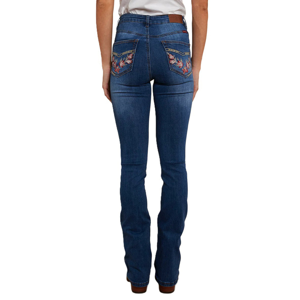 A woman shown from behind modelling a pair of Vintage Blue Wash Ringers Western Women's Penny Rodeo High Rise Bootleg Jeans (222104RW) with floral embroidery on the back pockets, on a white studio background.