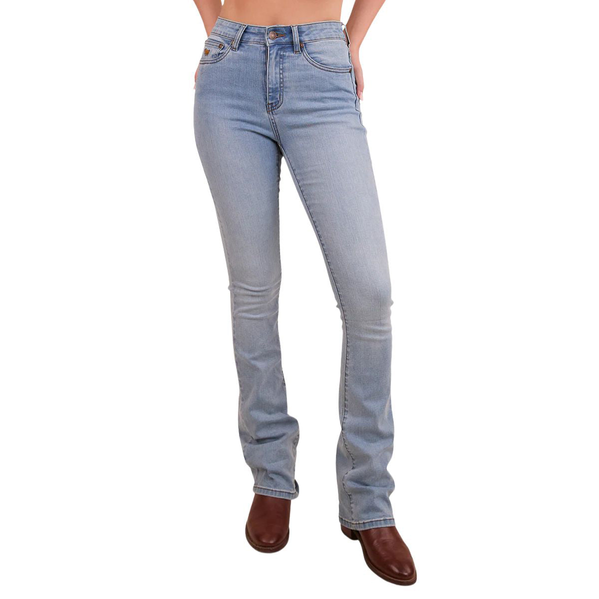 A woman viewed from the waist down modelling vintage light blue Ringers Western Women's Penny Rodeo High Rise Bootleg Jeans (222104RW) with a black rodeo rider print on the back pockets, paired with brown boots and on a white studio background.