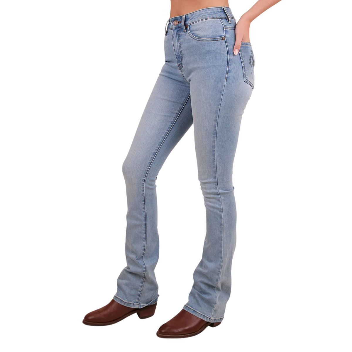 A woman viewed from the side from the waist down modelling vintage light blue Ringers Western Women's Penny Rodeo High Rise Bootleg Jeans (222104RW) with a black rodeo rider print on the back pockets, paired with brown boots on a white studio background.