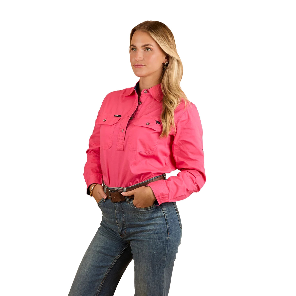 A woman with long blonde hair smiles, wearing the Ringers Western Womens Pentecost River Half Button L/S Work Shirt in Melon and blue jeans. She stands against a white background with her hands in her front pockets.