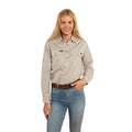 A woman with long blonde hair smiles against a white background, wearing the Ringers Western Womens Pentecost River Half Button L/S Work Shirt in beige and blue jeans, with one hand in her pocket.
