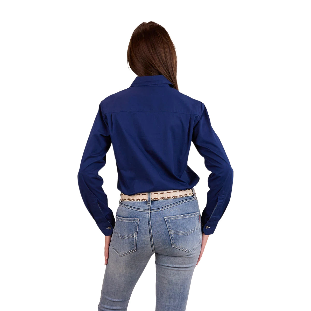 A woman with long dark hair has her back to the camera, wearing a Ringers Western Womens Pentecost River Half Button Work Shirt in Navy and blue jeans with a light coloured belt. The background is plain white.