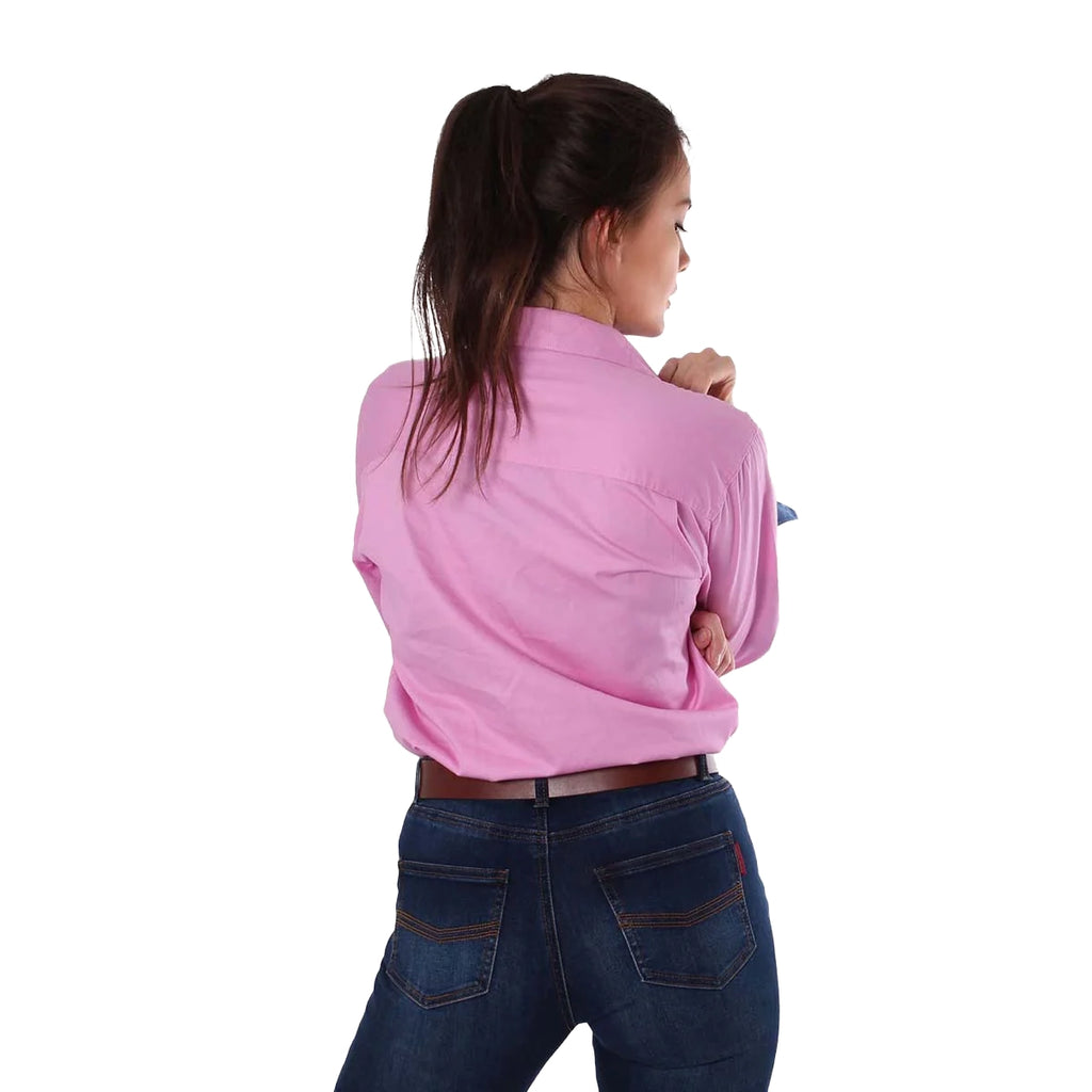 A woman with long brown hair with her back to the camera, wearing a Ringers Western Womens Pentecost River Half Button L/S Work Shirt in pastel pink and blue jeans against a white background.