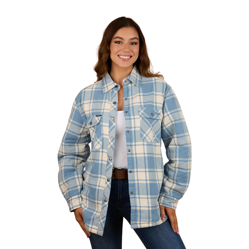 A woman smiles against a white background, wearing the Ringers Western Womens Sadie L/S Sherpa Flannel Shirt (224094RW) in Faded Denim/Off White over a white top, paired with blue jeans and a brown belt.