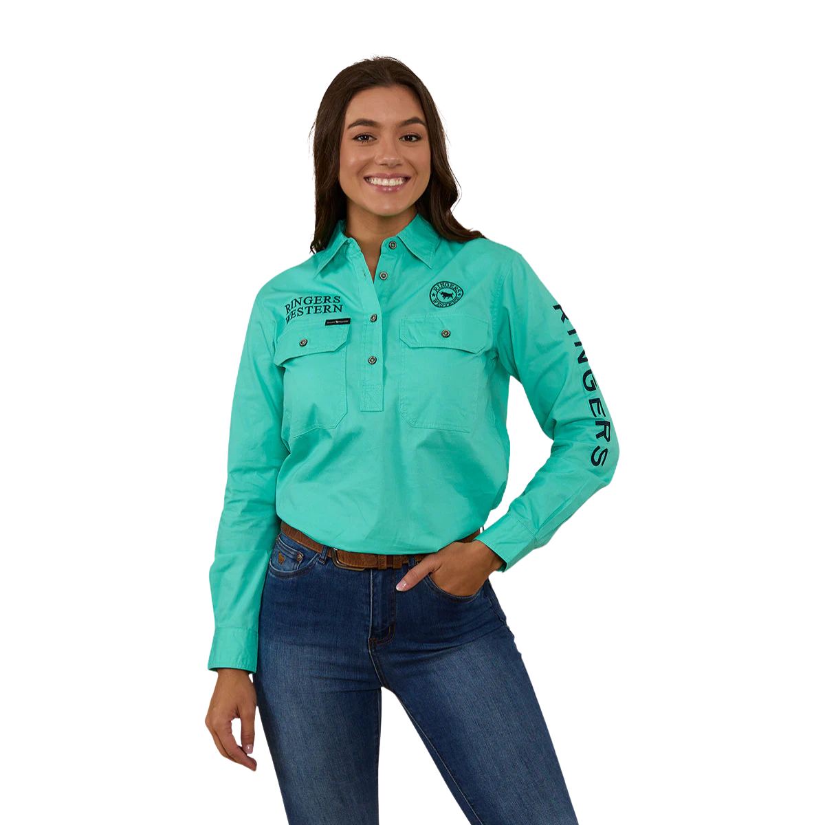 A woman in a Ringers Western Womens Signature Jillaroo Half Button L/S Work Shirt (223125RW) Mint/Navy, with "RINGERS WESTERN" branding, and blue jeans stands smiling against a plain white background.