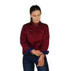 A woman smiles with one hand on her shirt cuff, wearing the Ringers Western Womens Pentecost River Half Button Work Shirt in Burgundy, standing against a plain white background.