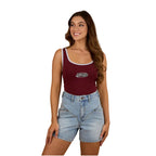 A woman wearing a Ringers Western Womens Villa Ringer Tank in Burgundy/Light Blue and light denim shorts with embroidered back pockets, set against a white background.