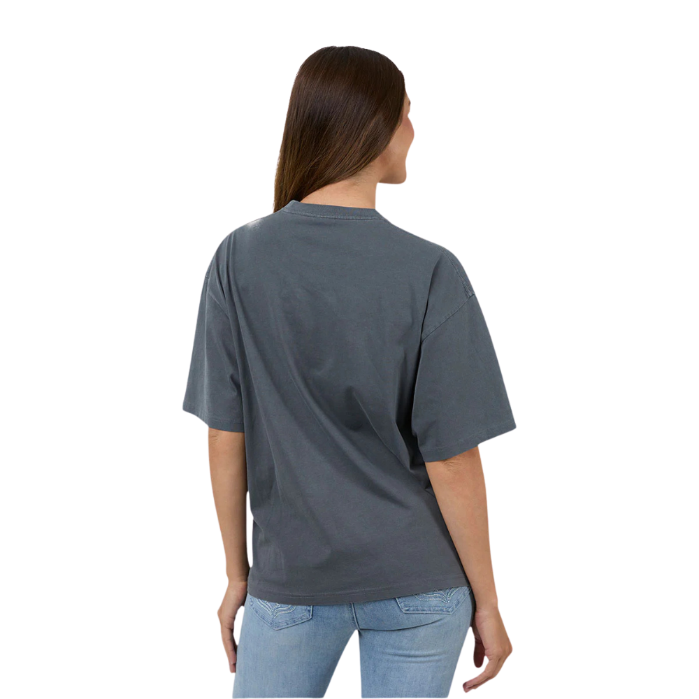 A woman with her back to the camera wearing a Ringers Western Women's Who Gives A Buck S/S Oversized Tee (225120RW) Washed Black on a white  background