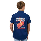 Child wearing a blue shirt with a bull riding champion design on the back