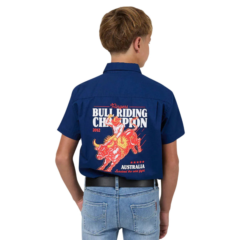 Child wearing a blue shirt with bull riding championship design on the back