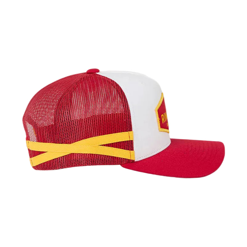 A red and white trucker-style cap with yellow accents, featuring a red mesh back, a red curved brim, and a small yellow patch on the side, set against a white  background.