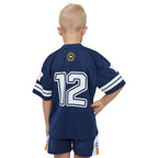 Child wearing a navy sports jersey with number 12 on a white background